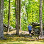 Hiker wanders among rocks near River Expeditions