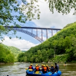 Paddlers gather near New River Gorge Bridge