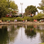Festival goers cool off at Coffman Park lake
