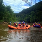 Rafts gather beneath the New River Gorge Bridge