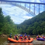 Rafts gather beneath the New River Gorge Bridge