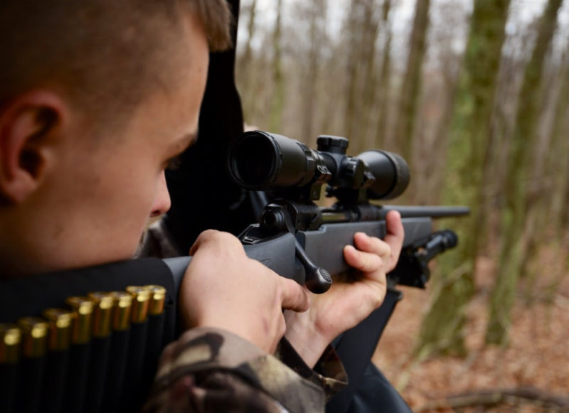 A West Virginia hunter sights his gun.