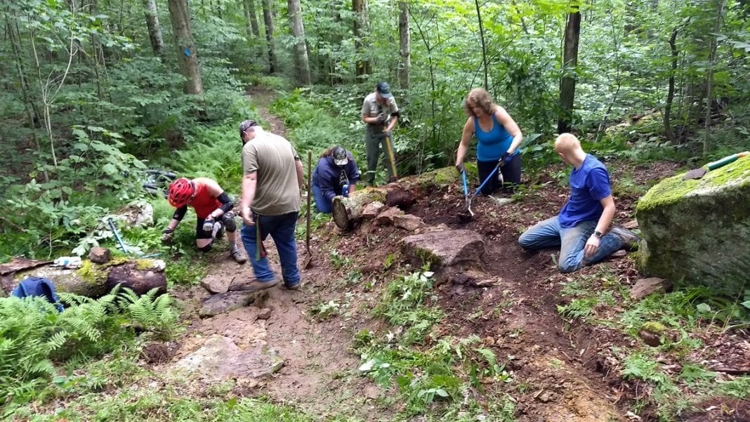 Volunteers with the New River Gorge Trail Alliance repair trail in the Monongahela National Forest with forest service staff and Youth Conservation Corp members.