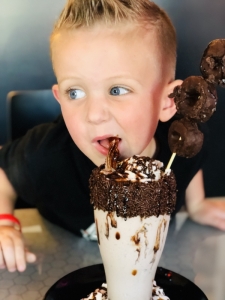 A young customer at "I Scream Sundae," attacks a ice cream treat.
