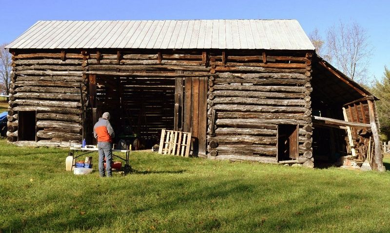 A researcher prepares to collect tree-ring samples from The Pitsenbarger Barn in Pendleton County.