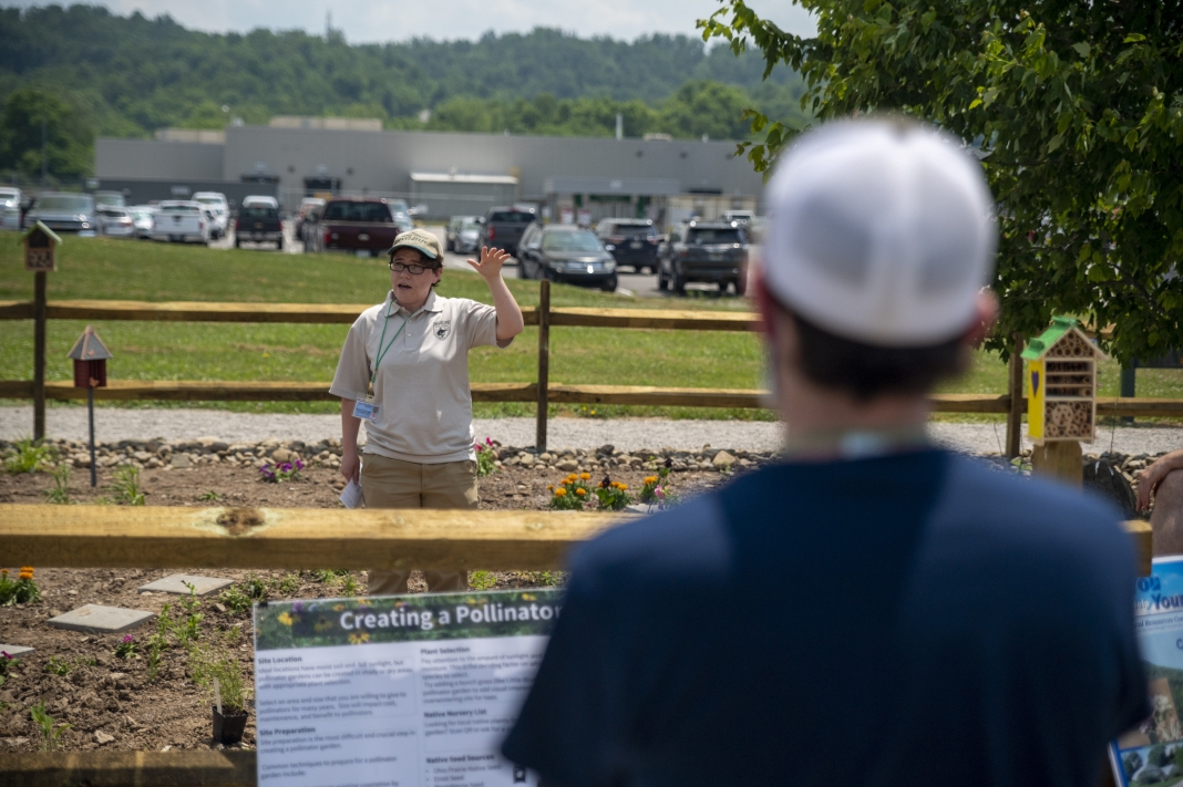 Rachel Rosenberg, a partner biologist with W.Va. Division of Natural Resources and Natural Resources Conservation Service, demonstrates planting techniques.