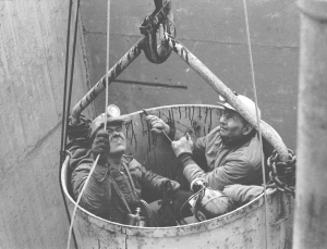 Farmington Mine Disaster survivors Gary Martin (left), and Bud Hillberry (right) and an unidentified third miner are hoisted from the Farmington No. 9 mine. They were the last to escape. (Photo by Bob Campione)