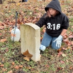 Volunteer in cemetery cleanup