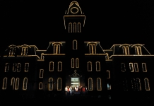 WVU revives Woodburn Hall lighting, illuminating legacy of higher ed in West Virginia Woodburn Hall History: Holiday carolers sing outside the entrance to Woodburn Hall.