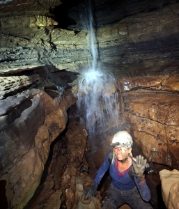 A caver visits a small waterfall in Piercy's Cave. (Photo courtesy Bill Balfour)